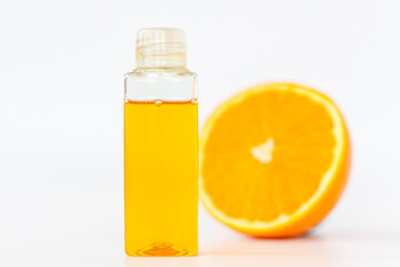 Orange oil for the body. Cut orange on a white background. Organic SPA cosmetics with herbal ingredients.