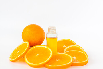 Orange oil for the body. Sliced orange on a white background. Organic SPA cosmetics with herbal ingredients.