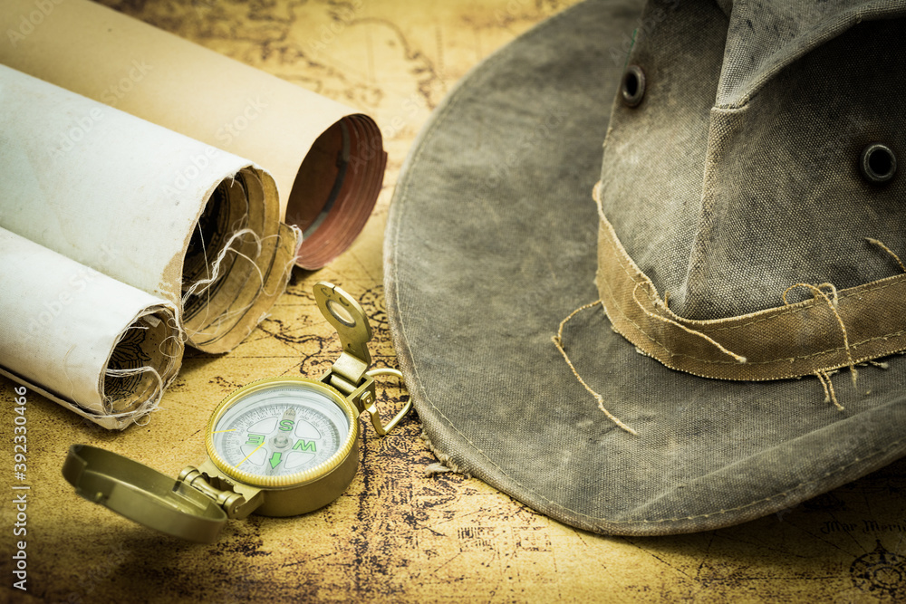 Poster old maps with a compass. and hat. the concept of expeditions and travel, discovering the world