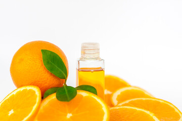 Orange oil for the body. Sliced orange on a white background. Organic SPA cosmetics with herbal ingredients.