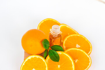 Orange oil for the body. Sliced orange on a white background. Organic SPA cosmetics with herbal ingredients.