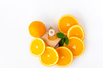 Orange oil for the body. Sliced orange on a white background. Organic SPA cosmetics with herbal ingredients.