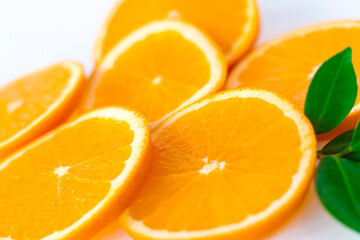 Fototapeta na wymiar Cut orange on a white background. Natural orange fruit with cut slices. Vitamin C.