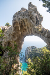 View of natural rock arch with the sea in the background.