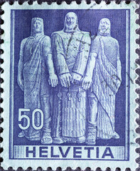 Switzerland - Circa 1941 : a postage stamp printed in the swiss showing three men as symbols of the...