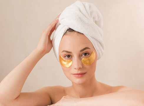 Beauty face woman natural healthy cosmetic skin pure suresh beautiful female happy smile portrait manicure hand. Beauty portrait of an attractive girl with a gold patch under the eyes.