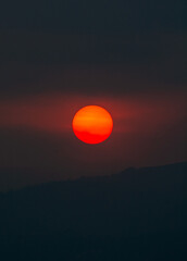 Beautiful heavenly colored sun entering the horizon, wonderful sunset