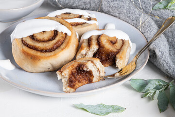 Cinnamon rolls or cinnabon  with icing for Christmas. Homemade traditional winter festive dessert buns. Pastry food for breakfast on white background