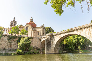 Fototapeta na wymiar the old bridge over Tamega river and the monastery of Sao Goncalo in Amarante city, Porto District, Douro Litoral, Portugal