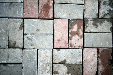 pavement of gray and red bricks, close-up as texture for background