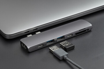 Close-up photo of laptop, type-c hub with cable and usb receiver