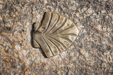 metallic symbol of the way of Saint James - the shell on the floor