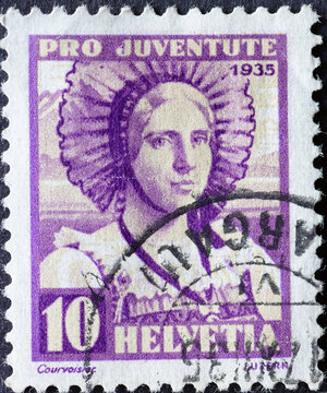 Switzerland - Circa 1935 : a postage stamp printed in the swiss showing the portrait of a woman from Lucerne in historical costume