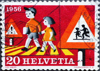 Switzerland - Circa 1956 : a postage stamp printed in the swiss showing two children on pedestrian...