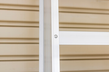 Fototapeta premium An aluminum foldable ladder on the wall
