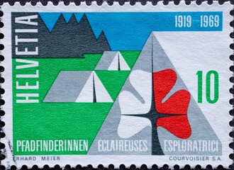 Switzerland - Circa 1969 : a postage stamp printed in the swiss showing a camp of scouts with a...