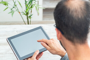 Man from behind using tablet