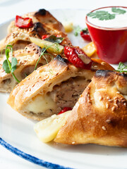 Closeup of  sliced freshly baked burek or burekas with chicken, studio shot, selective focus