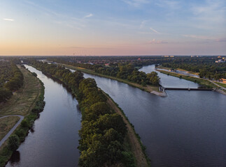 Fototapeta na wymiar Morning aerial cityscape over coasts, islands and peninsula on Odra river in Wroclaw city