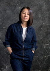 Beautiful korean woman dressed in jumpsuit studio portrait.