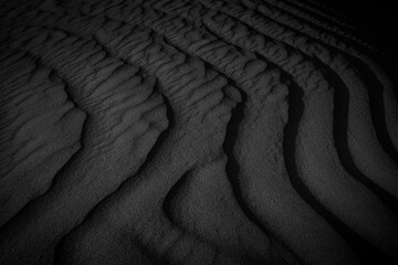 Black and White Sand beach macro photography. Texture of black and whote sand for background. Close-up macro view of volcanic sand surface black and white color. 