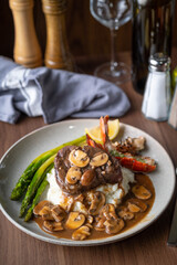 surf and turf, lobster tail and tenderlon steak with mushroom gravy sauce