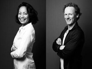 Two beautiful people in front of a background