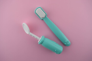 Toothbrush and dental mirror toy on the pink background