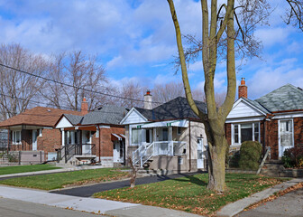 Street with row of modest 1950s style working class bungalows