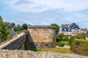 Fototapeta na wymiar Dinan, France - August 26, 2019: View of the historic town and medieval ramparts which still surround the Old Town of Dinan in French Brittany