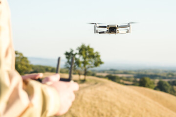 Person controlling drone from the distance, selective focus