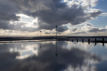 Reflections on Westcliff beach, near Southend-on-Sea, Essex, England