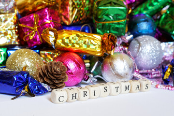 The inscription Christmas and a lot of New Year's gifts and toys on a white background. Celebrating...