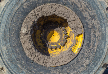 close up of a large heavy duty tractor tire caked with mud