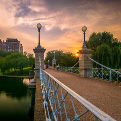 The sun sets over the footbridge in the Boston Public Garden 