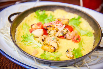 omelet with seafood in a pan