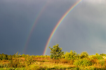 Double rainbow over the stormy sky