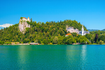 Fototapeta na wymiar Cozy Lake Bled in summer with the Juliet Alps in the background of the beautiful castle
