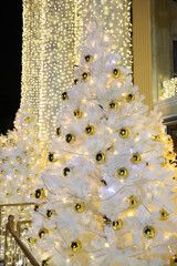 Sparkling gold led lights and white Christmas tree with Golden balls