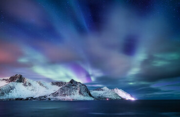 Aurora borealis in Norway. Green northern lights above mountains and ocean. Night winter landscape with aurora. Natural p henomenon background in Norway. - obrazy, fototapety, plakaty