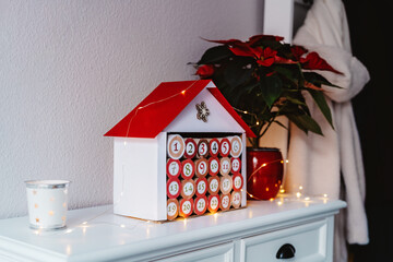 Handmade advent calendar house made from toilet paper rolls and carton. Sustainable Christmas,...