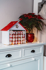 Handmade advent calendar house made from toilet paper rolls and carton. Sustainable Christmas,...