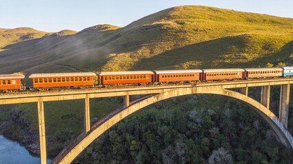 Maria Fumaça train passing on the Rio Pelotinhas railway bridge. Aerial view of the train passing on the bridge