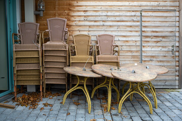 Stacked tables and chairs on the terrace of a restaurant, closed during lockdown due to coronavirus pandemic