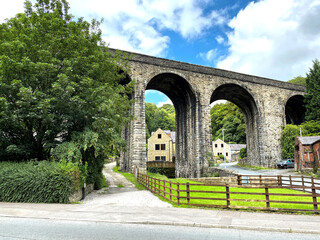 Victorian stone built viaduct, with trees and houses nearby in, Lydgate, Burnley Road, Todmorden, UK