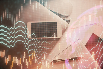 Multi exposure of forex graph hologram over desktop with phone. Top view. Mobile trade platform...