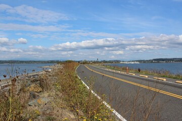 Fototapeta premium Semiahmoo Pkwy and a trail along the Semiahmoo Spit, shore on Semiahmoo Peninsula between Semiahmoo Bay and Drayton Harbor off the coast of Blaine 
