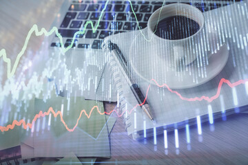 Double exposure of forex chart drawing and desktop with coffee and items on table background. Concept of financial market trading