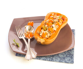 Butternut baked cut in half presented on a plate with old cutlery