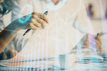 Double exposure of forex graph drawing over people taking notes background. Concept of financial analysis